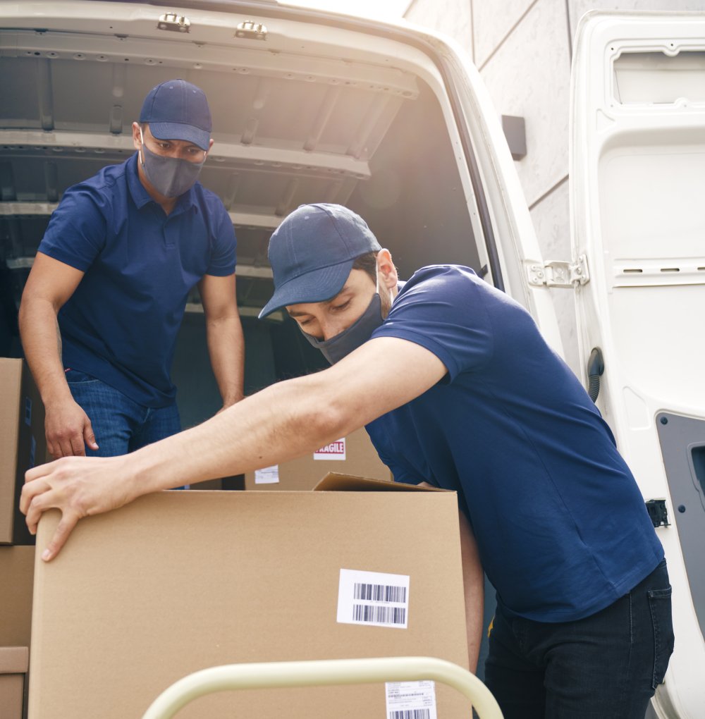 Quality Express Freight couriers loading consignments into a delivery van